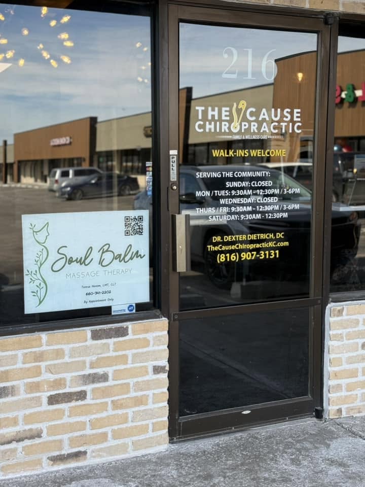 Soul Balm Massage Therapy signage in the window inside the Cause Chiropractor office